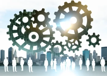 Interconnected gears representing wealth perception's impact on economy and consumer behavior.